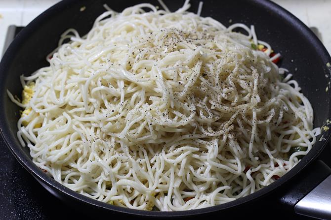 sprinkling pepper to pan for egg noodles recipe