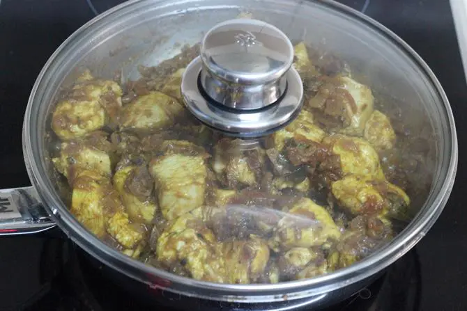 cooking pepper chicken on a low flame to make it tender