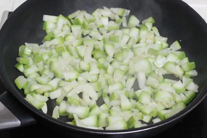 frying chilies gourd in oil to make sorakaya pachadi