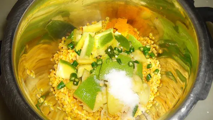 adding chopped mango dal chilies salt