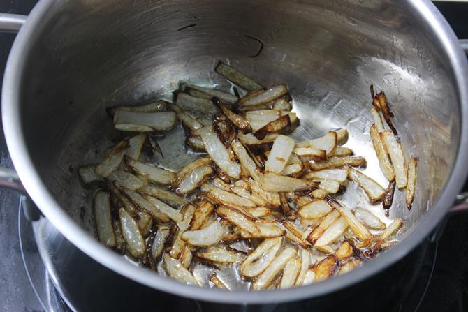 golden fried onions in pan for mushroom biryani recipe