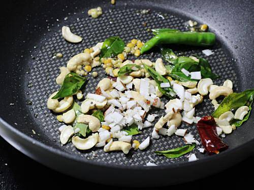 tempering with crisp fried curry leaves in a pan