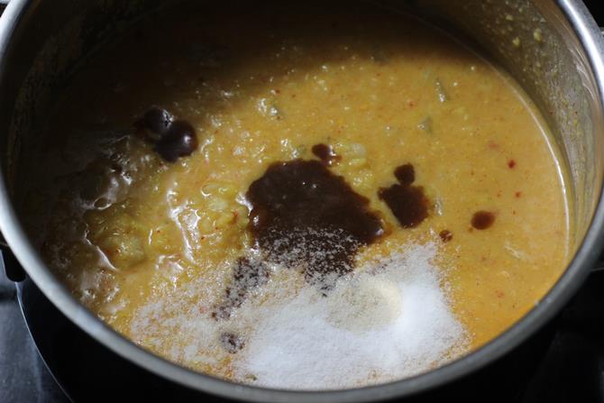 adding tamarind to cooking bottle gourd kootu
