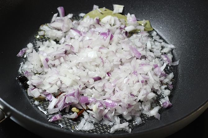 frying onions to make cauliflower kurma recipe
