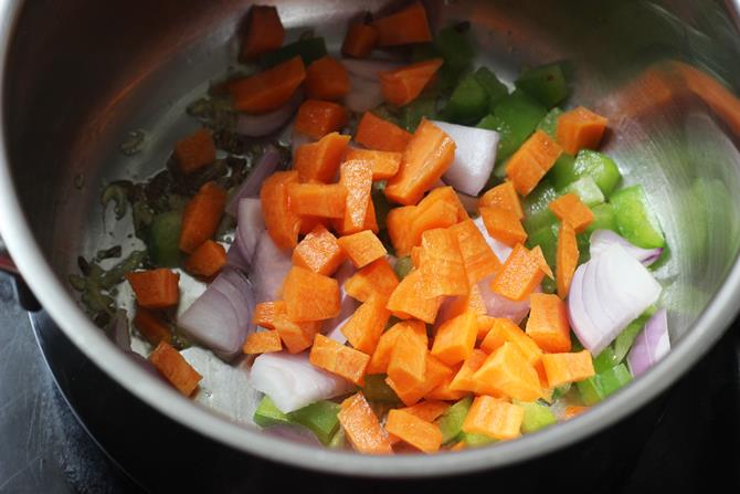 sauteing carrots potato gobi capsicum for making oats khichdi recipe