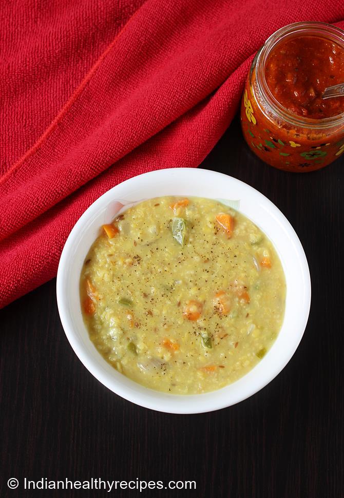 Serve warm oats khichdi with papad ghee