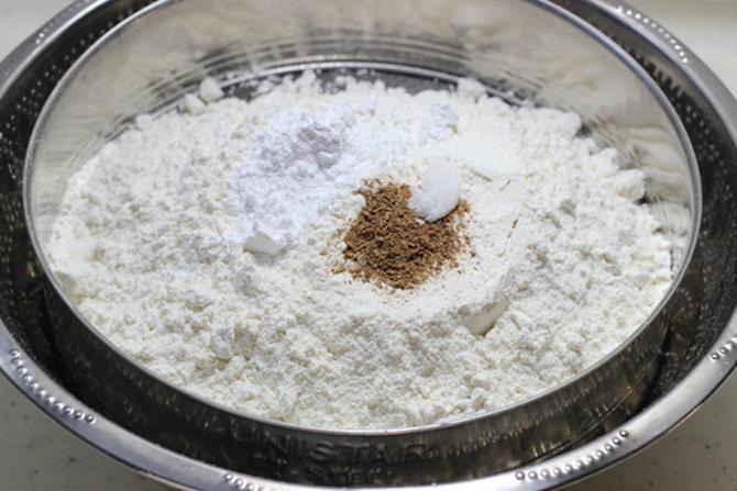 sieving ingredients for chocolate chip muffins recipe