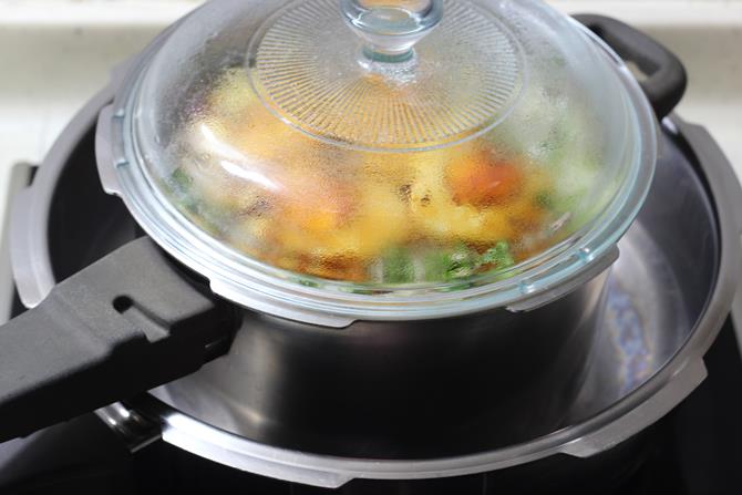 dum process on a hot tawa to make hyderabadi egg biryani