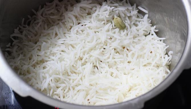 layering rice in pot to make egg dum biryani recipe