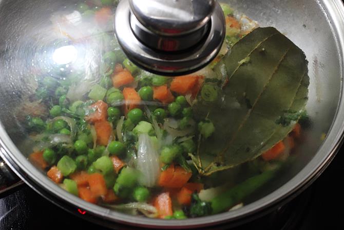 cooking veggies in pan to make semiya biryani recipe
