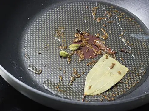 Frying cashews spices for carrot rice recipe