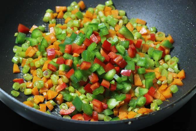 addition of bell peppers to the pan and fry in schezwan fried rice recipe