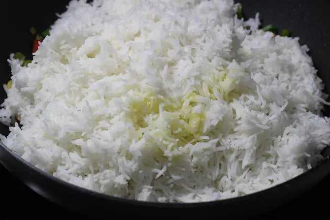 cooked and cooled rice added to the pan