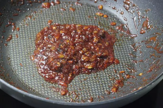 cooking sauce until thickened for schezwan fried rice