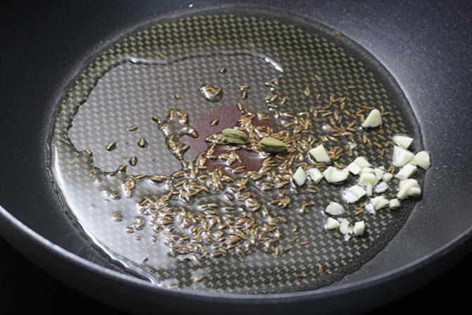 frying dry spices in ghee for methi rice recipe
