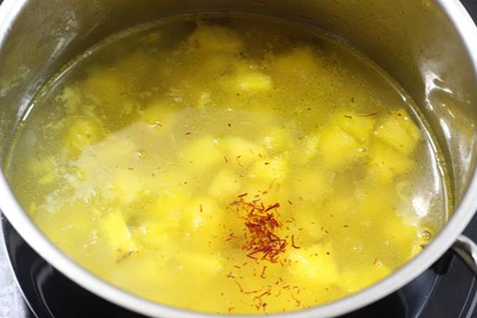 boiling fruit in water to make pineapple kesari