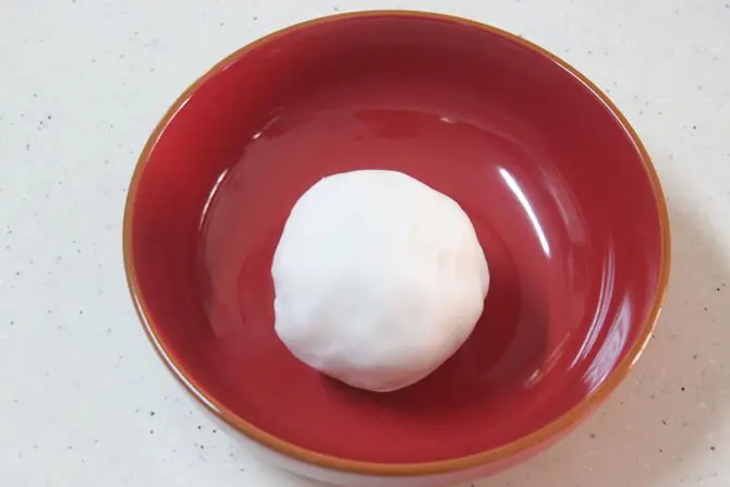 kneading rice flour dough for ellu kozhukattai