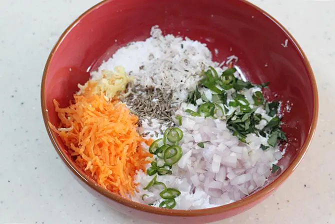 adding flour veggies to a bowl