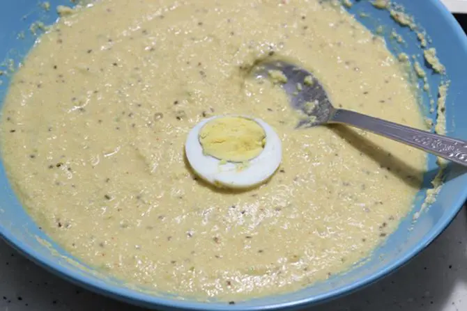 dipping egg slices in batter for egg bonda recipe