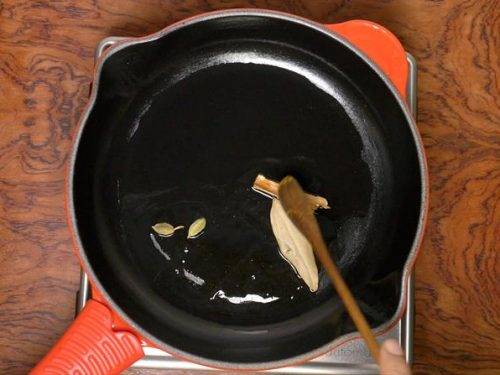 sauteing spices in oil to make matar paneer