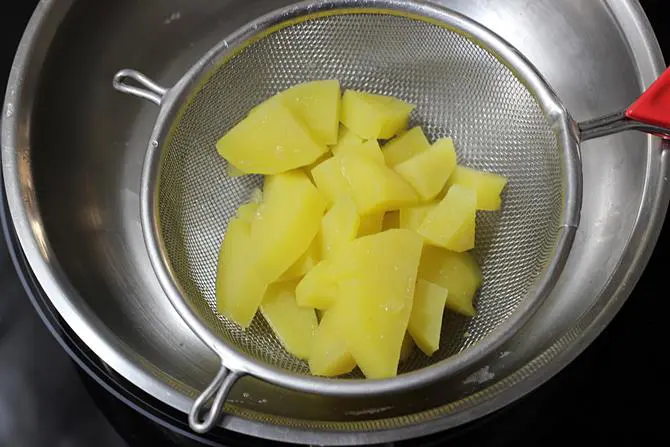 draining aloo for corn cutlet