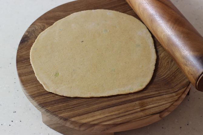 rolling dough to make dal paratha