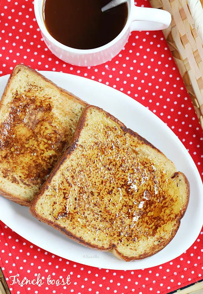 french toast in a serving basket with a cup of black coffee