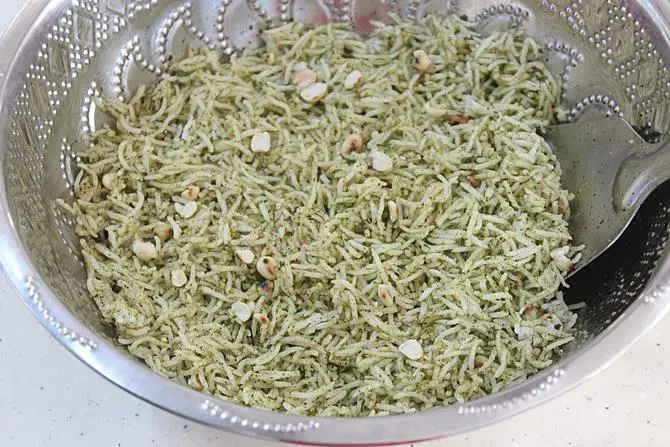 mixing curry leaves rice with karivepaku podi