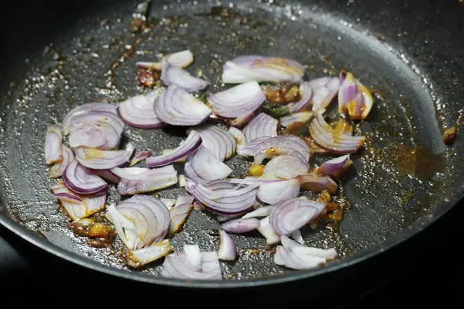 add sliced onions, slit green chili