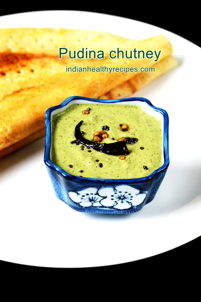 pudina chutney served in a blue bowl with dosa in a white plate