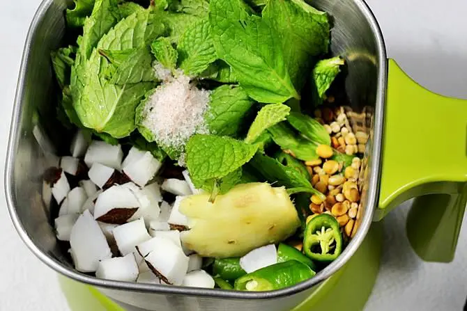 blending ingredients in a blender to make pudina chutney