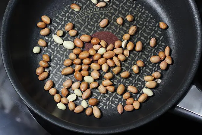 frying peanuts for stuffed brinjal fry