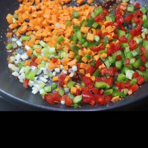 frying veggies to make chilli garlic noodles