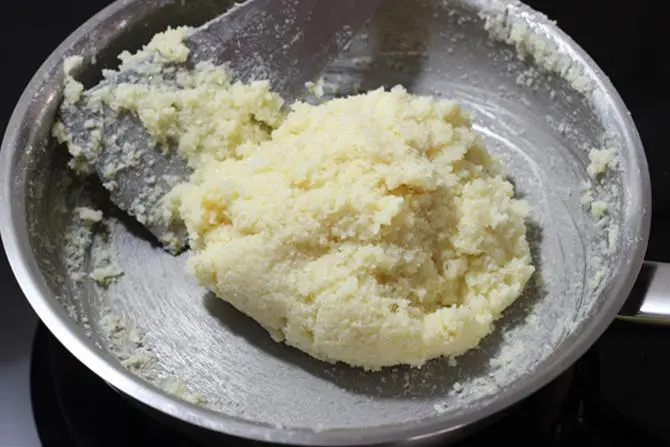 thickened mass of coconut ladoo with condensed milk mixture