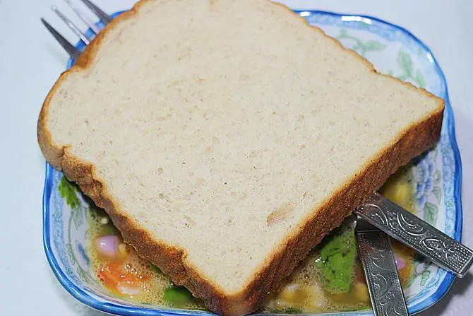 dipping bread in egg mixture for egg toast