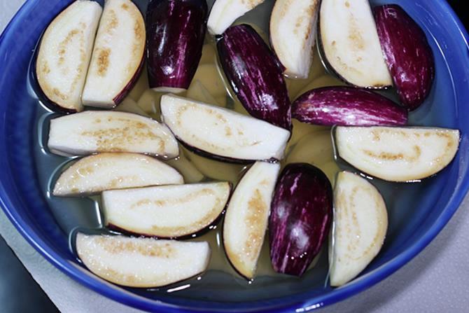 cut veggies in salt water to make aloo baingan masala
