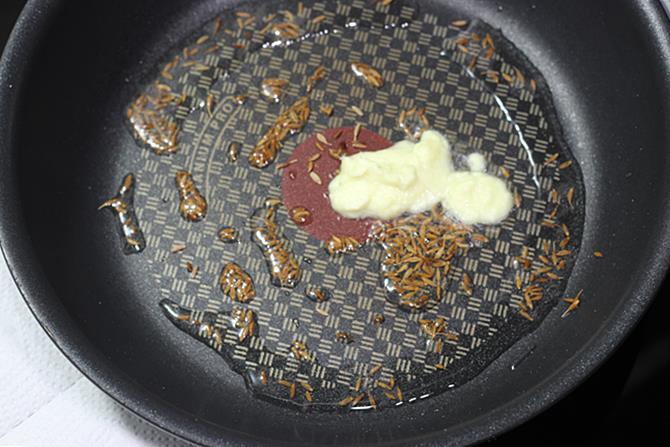 seasoning hing cumin for aloo baingan masala