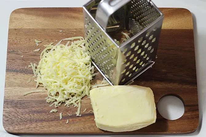 grating mozarella for garlic cheese bread toast
