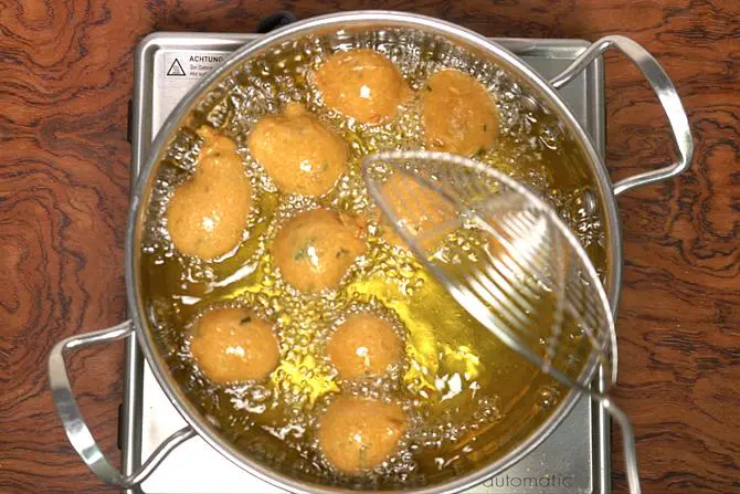 frying mysore bonda on a medium heat