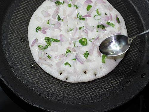 sprinkle toppings & oil to make uttapam recipe