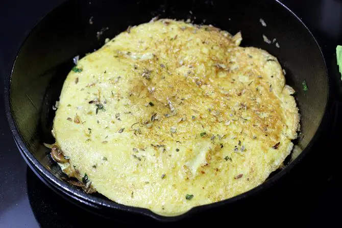 flipped mushroom omelette in pan