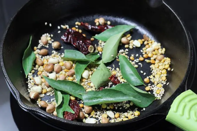 adding curry leaves to make podi idli