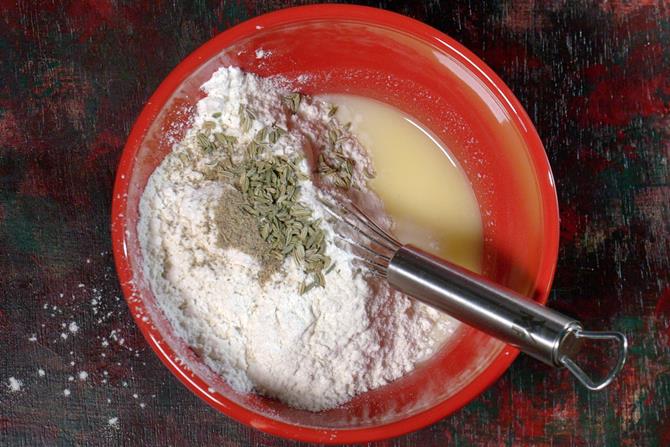 adding flour fennel to make malpua