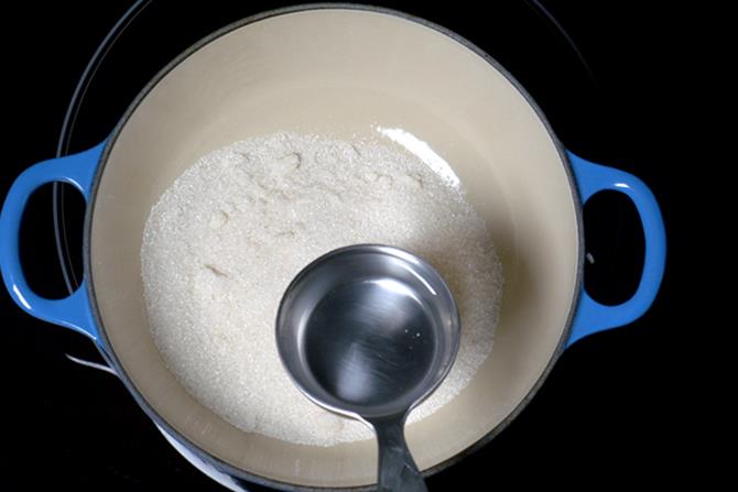 adding sugar to pot to make sugar syrup