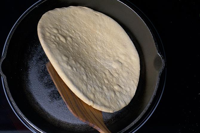 roti has puffed and cooked completely