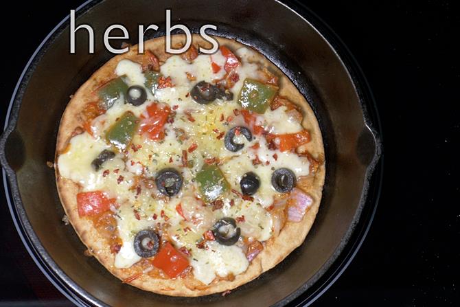 Sprinkle cheese, olives, herbs
