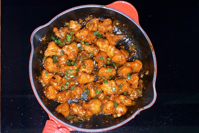 Garnish gobi manchurian with spring onions