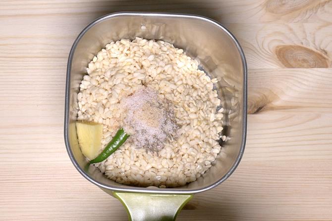 adding urad dal chilli salt ginger to mixer for dahi vada recipe