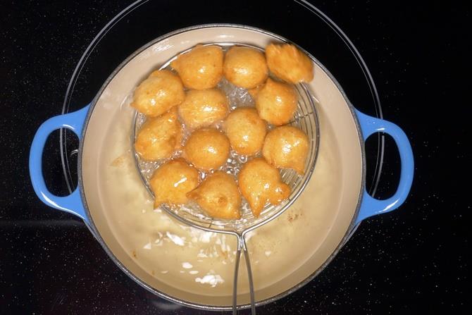 crisp golden fried dahi vada removing from oil
