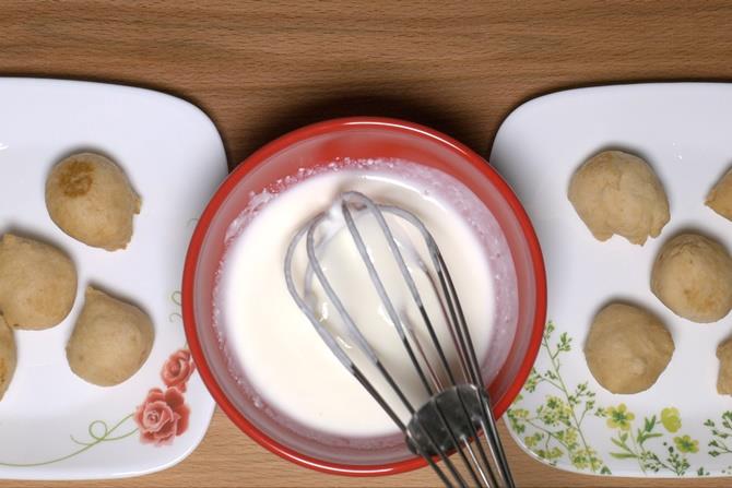 whisking yogurt to make dahi vada